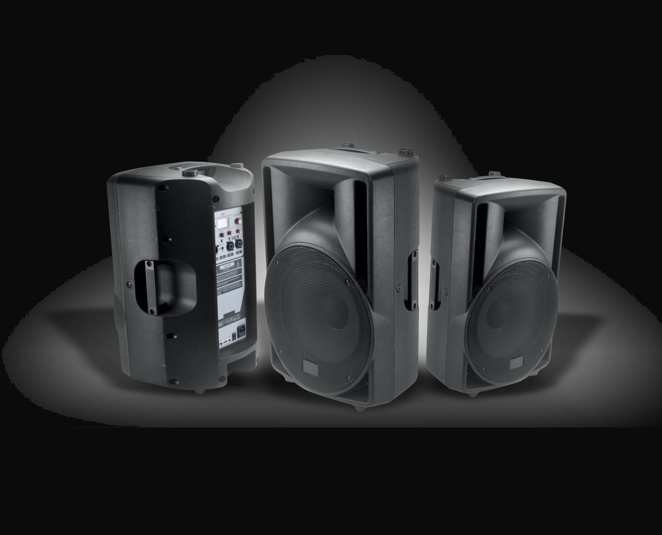 Three professional portable speakers with built-in amplifiers and control panels on curved platform