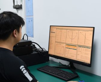 Engineer Klippel testing 1 Engineer using audio measurement system with waveform analysis displayed on monitor