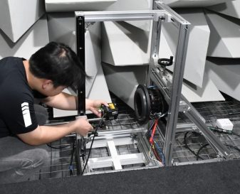 Engineer Klippel testing Engineer conducting audio speaker testing with precision measurement equipment in anechoic chamber